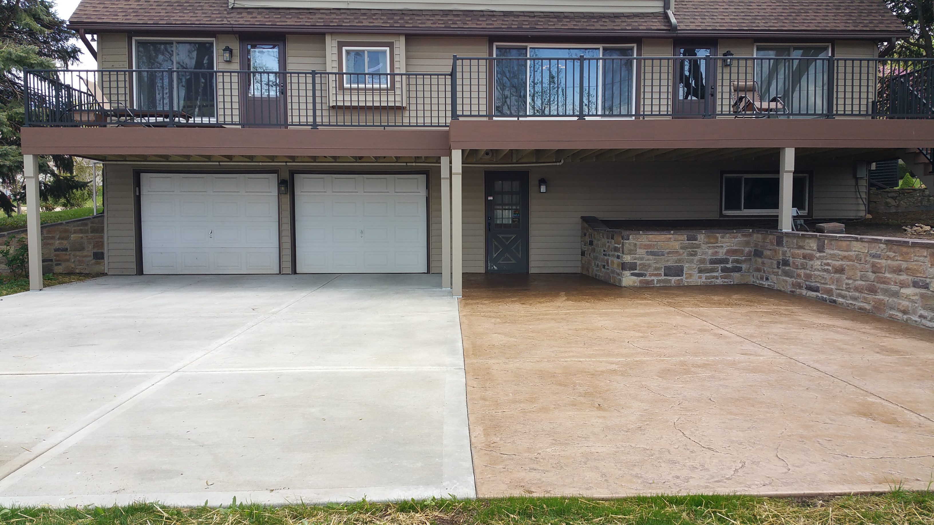 Side-by-side concrete driveways, one newly poured and one older.