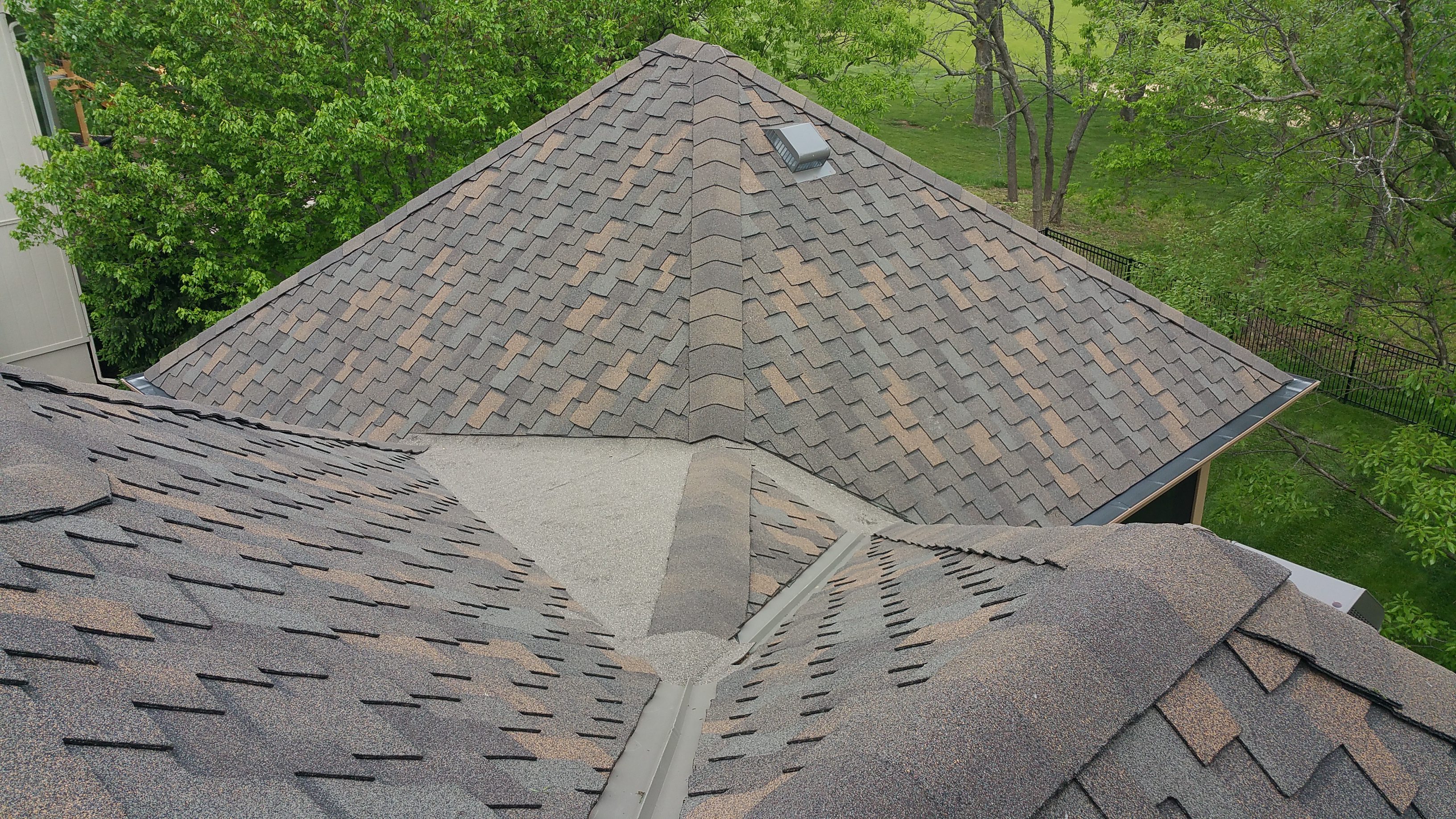 Close-up of a roof with asphalt shingles and a valley area.