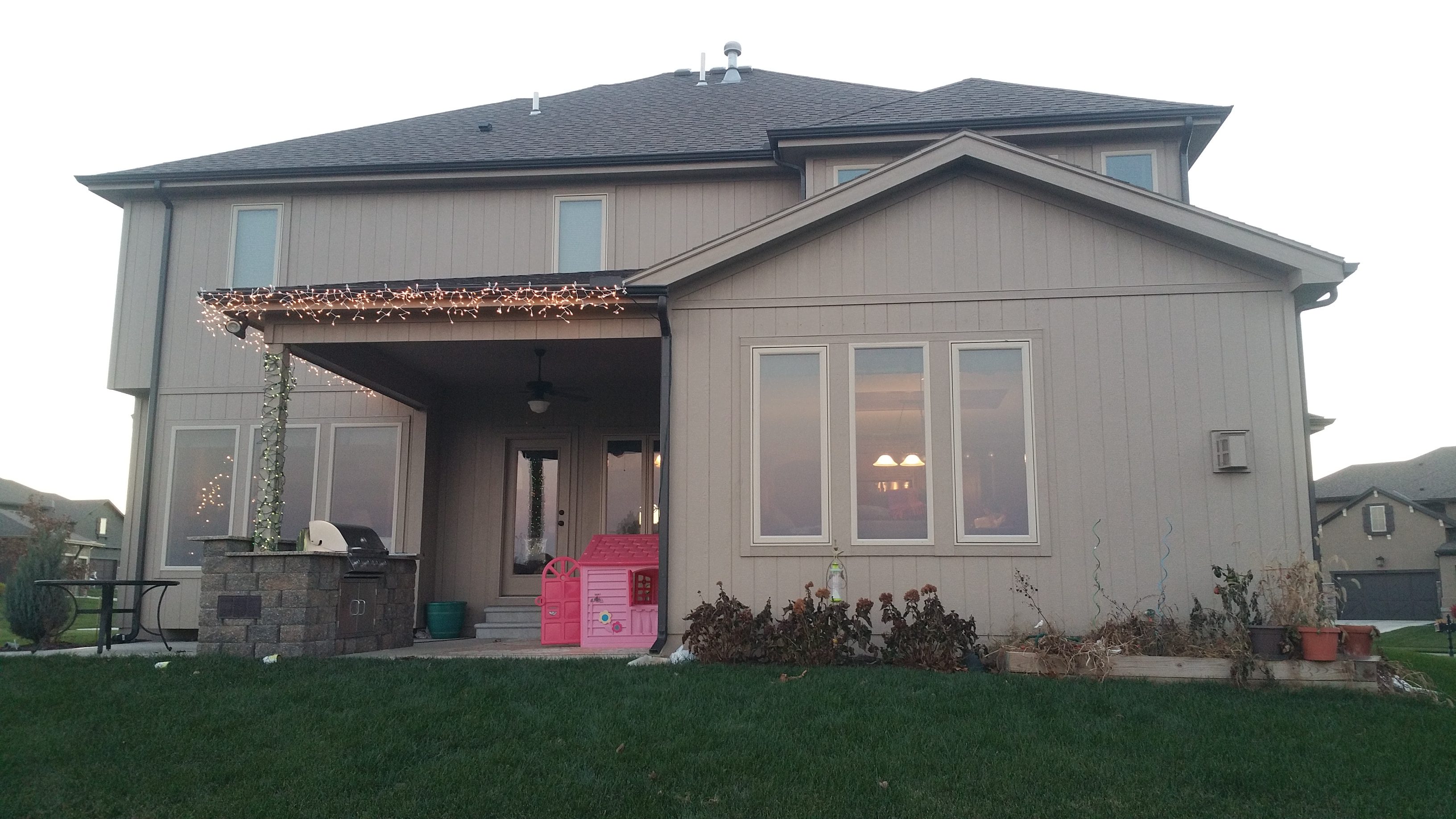 A suburban house exterior with a small porch and lawn.