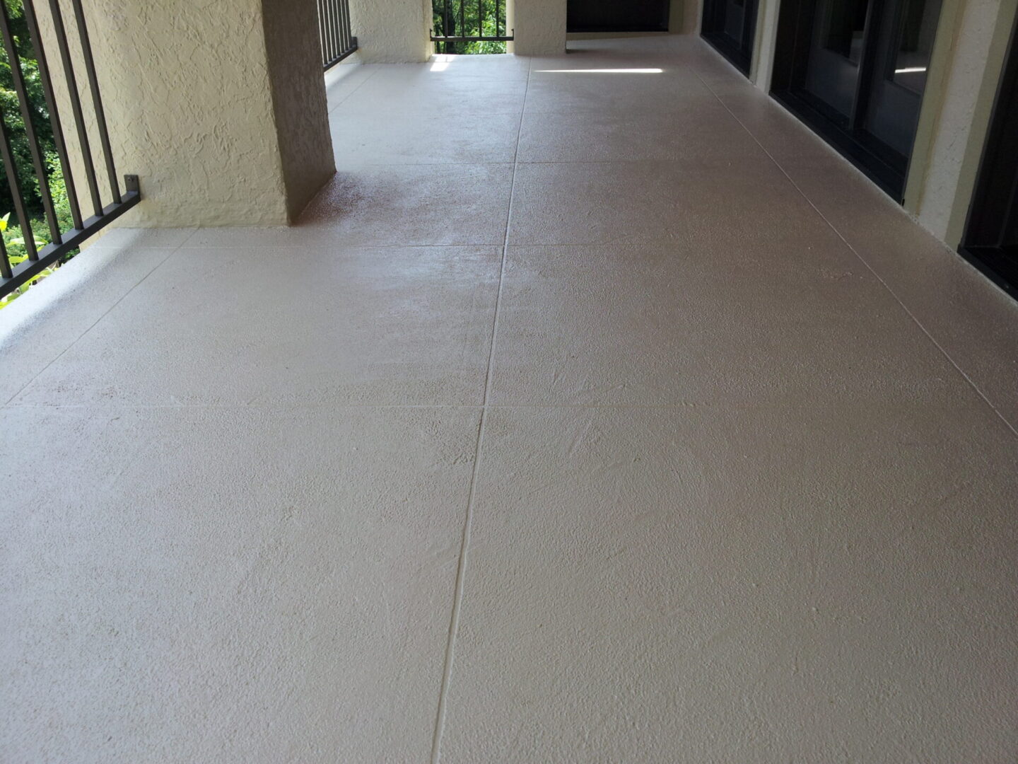A clean, beige tiled floor in a well-lit corridor area.