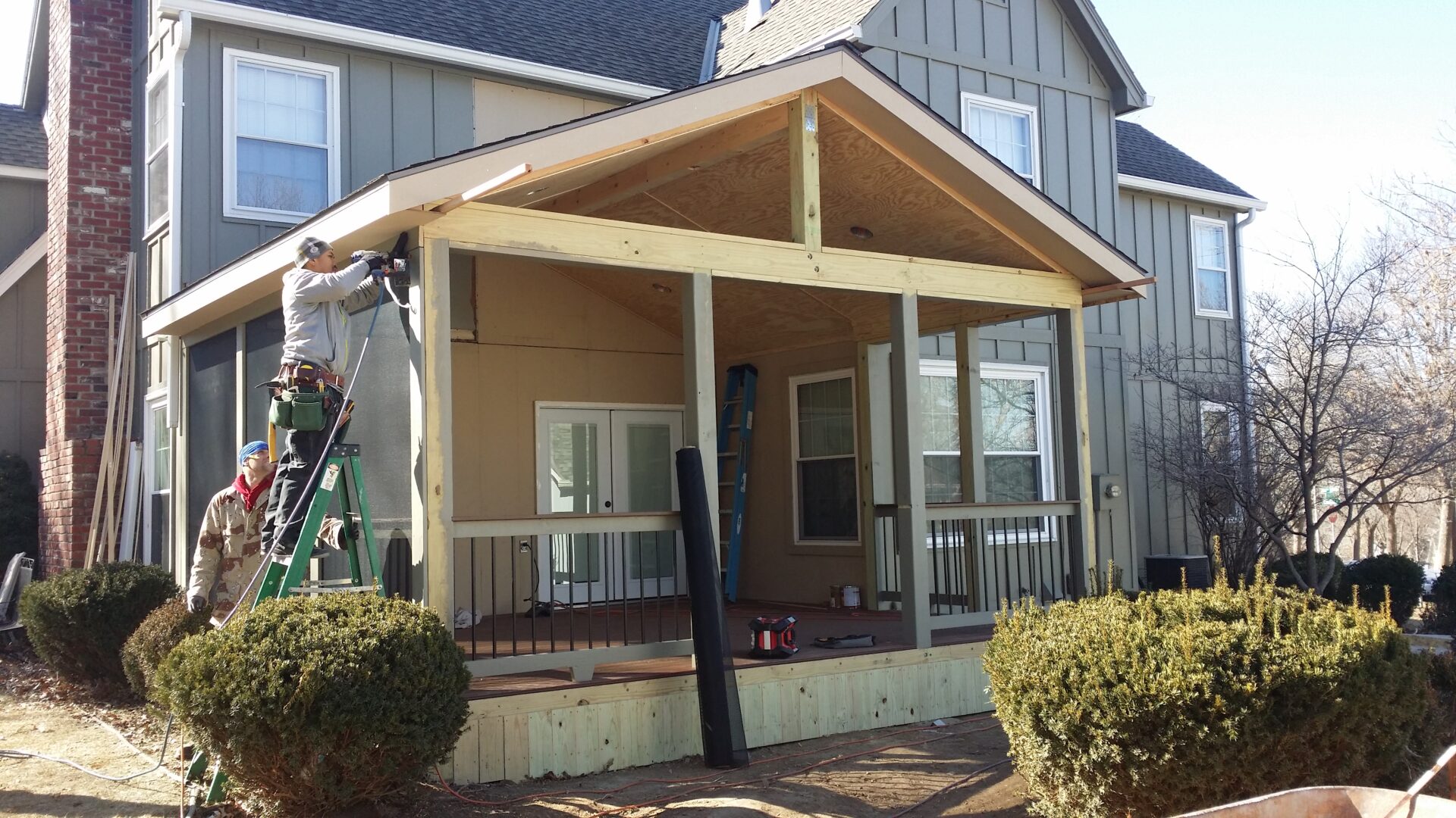 A newly constructed wooden porch attached to a house.