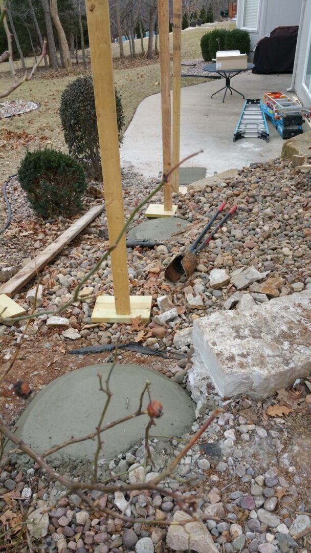 Trench dug for underground pipe installation near a building.