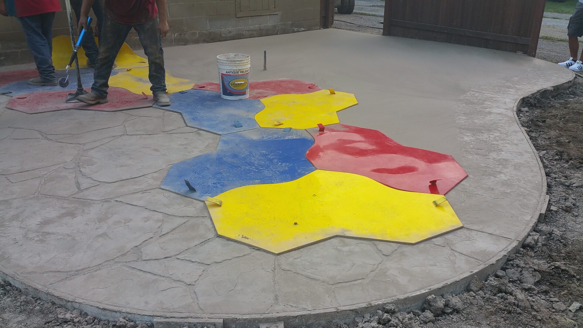 Painting colorful hexagonal tiles on the ground.