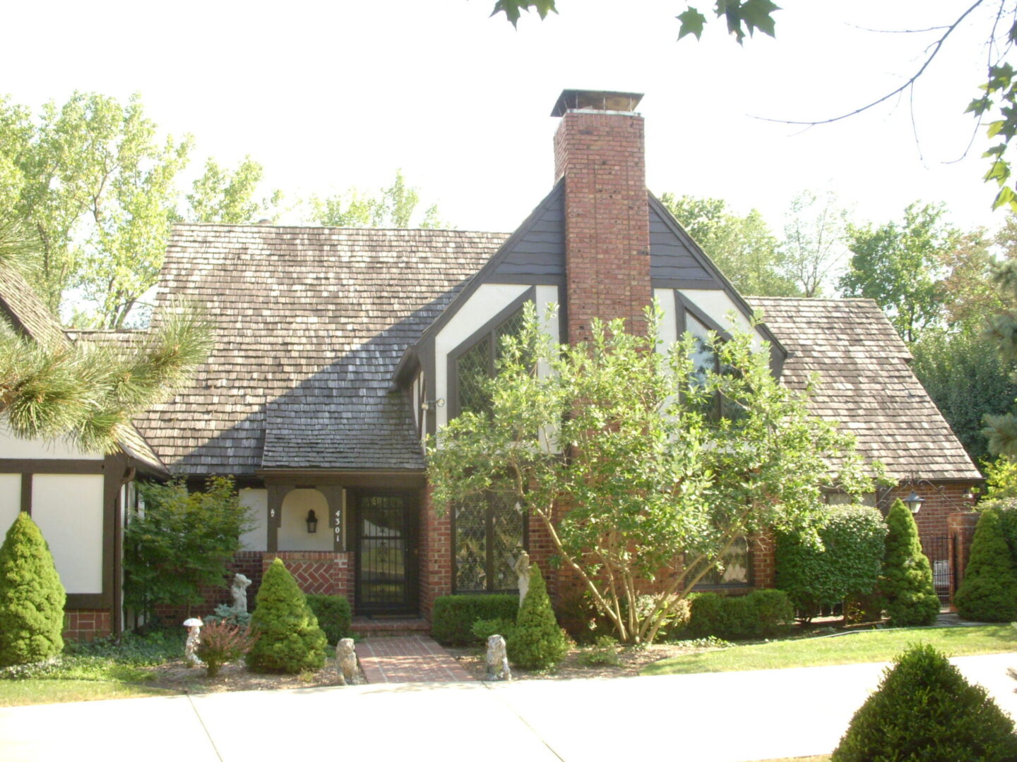 Charming cottage-style house with a steep roof and brick chimney.