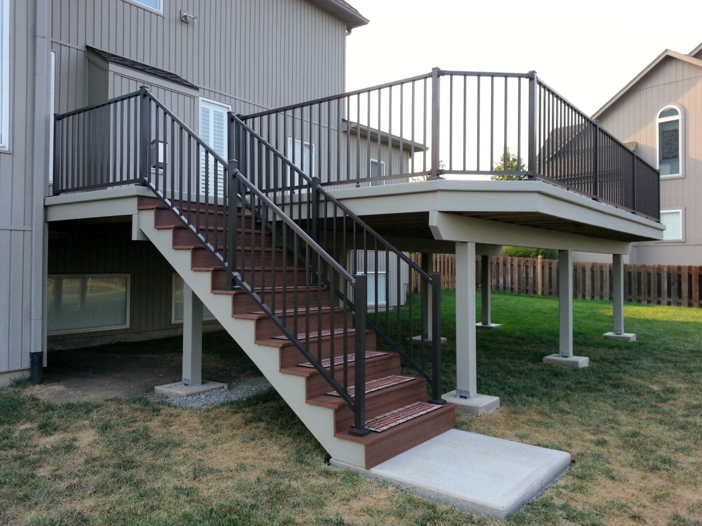 Outdoor staircase with metal railings and wooden steps.