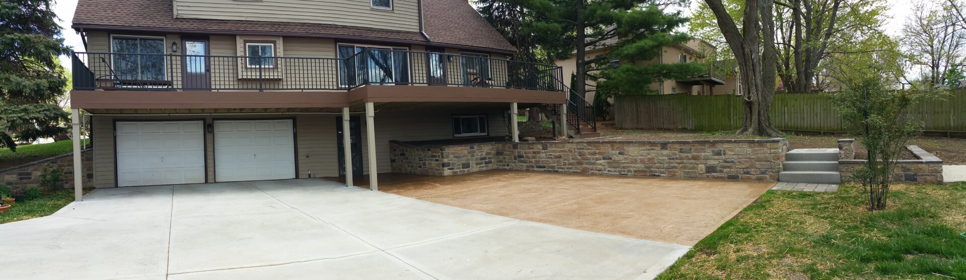 Spacious driveway and carport beside a two-story house.