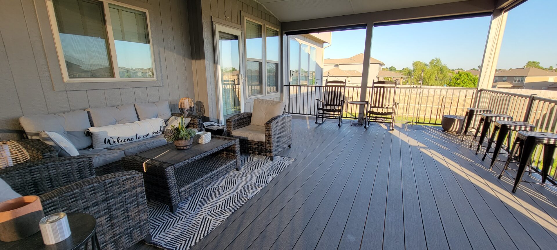 Cozy outdoor patio with seating and decorative plants.