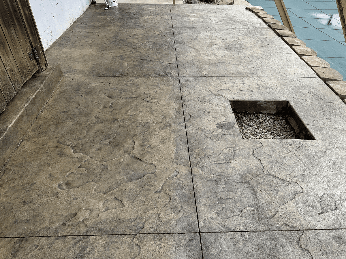 Concrete floor with a square cut-out section near the edge.