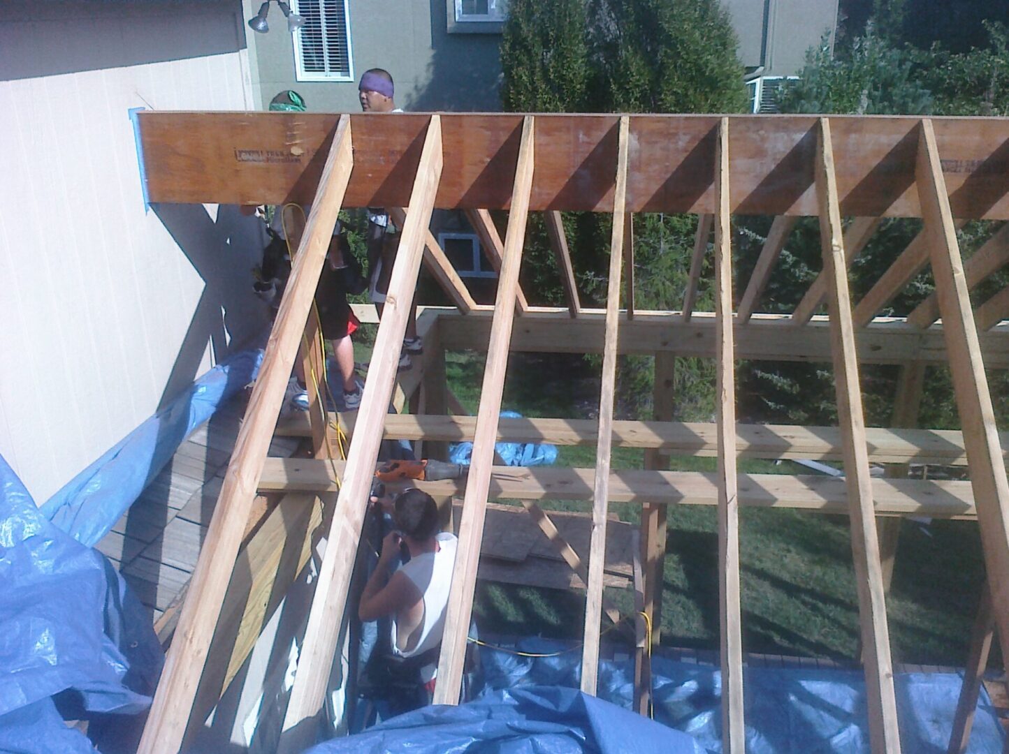 Wooden roof framing under construction on a residential building.