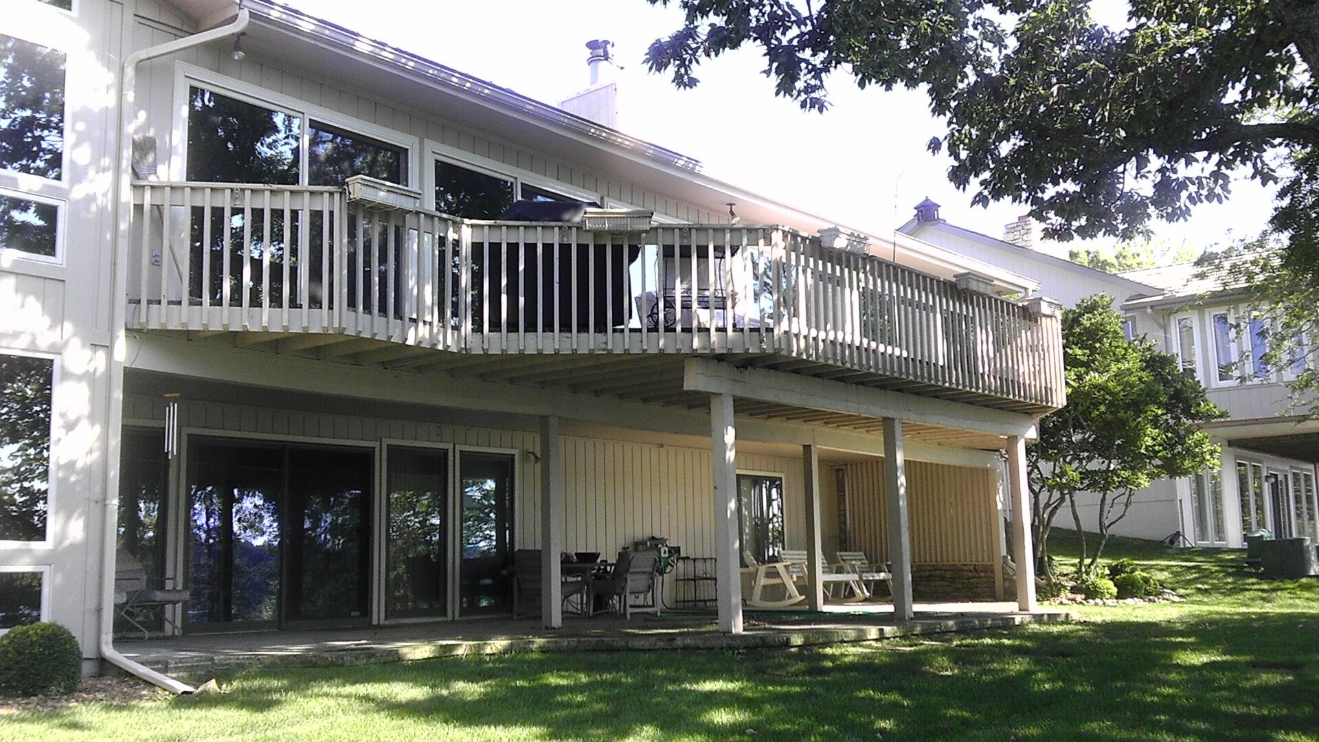 Two-story house with upper balcony and patio