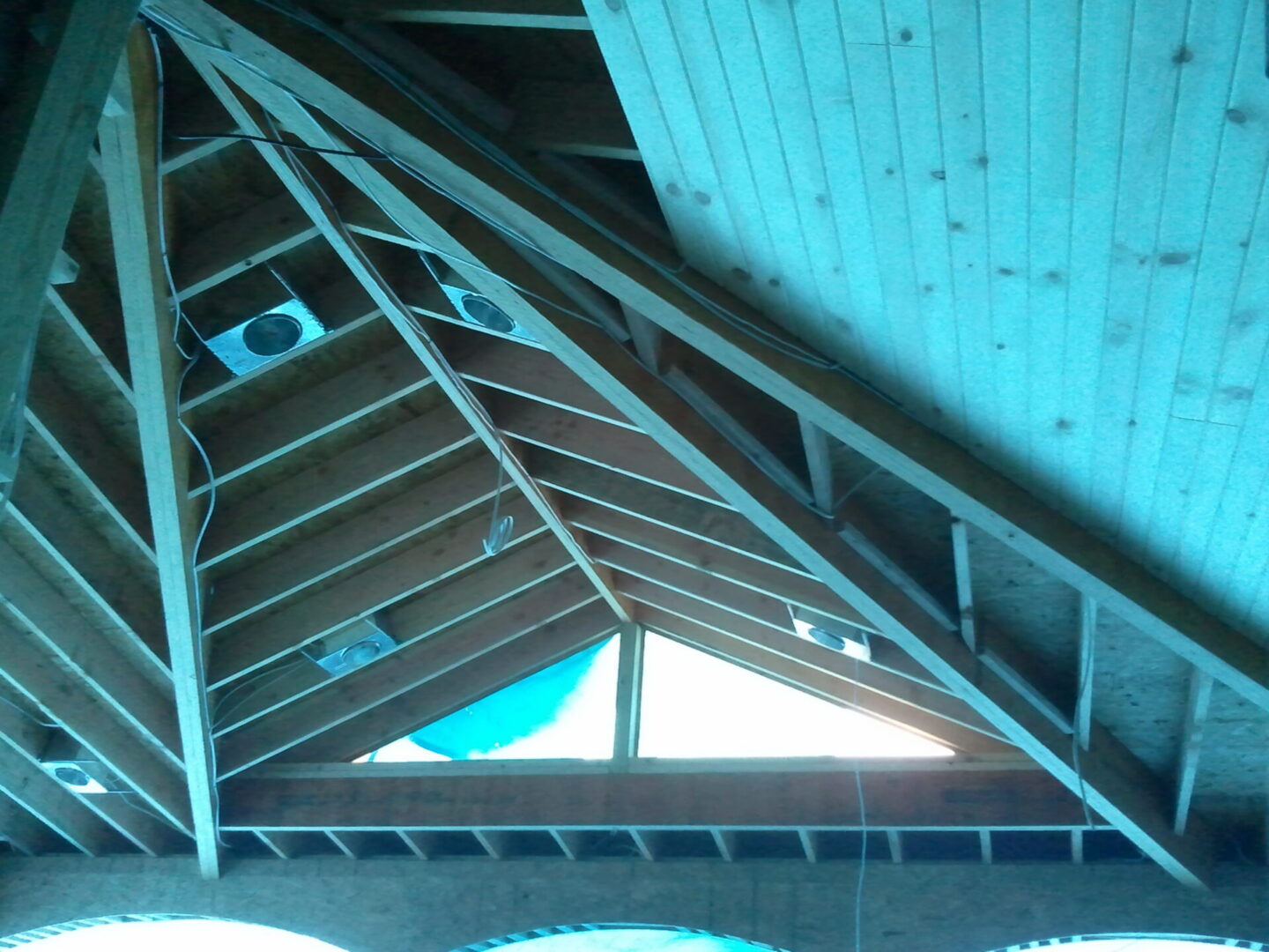 Exposed wooden rafters and triangular skylight