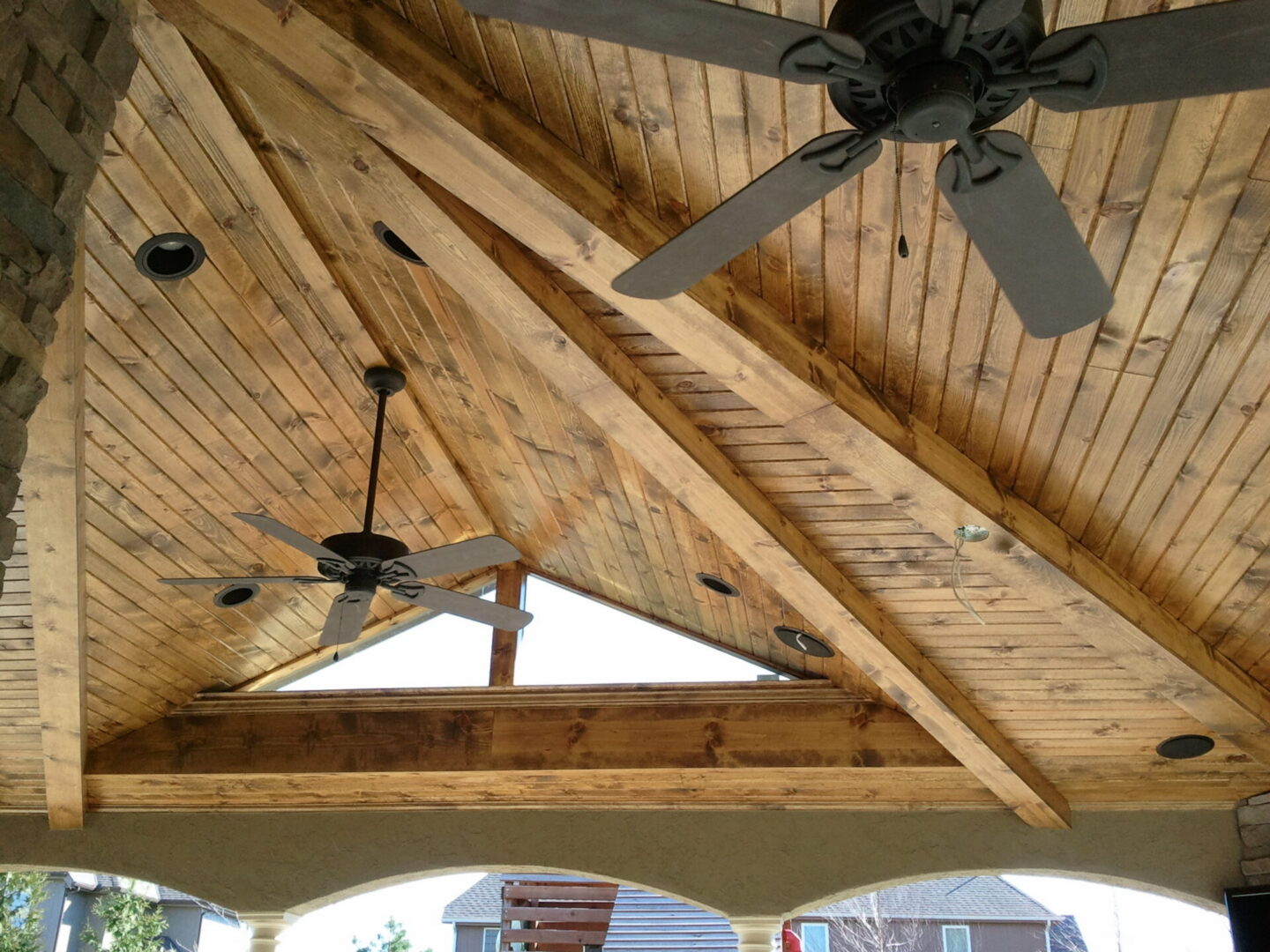 Wooden vaulted patio ceiling with fans