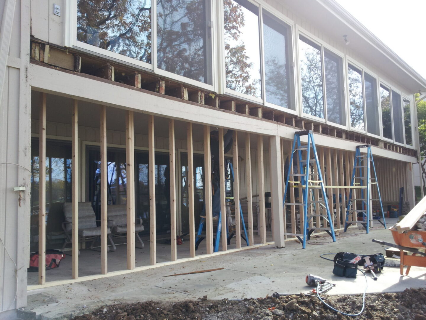 Exterior home renovation with exposed wall studs