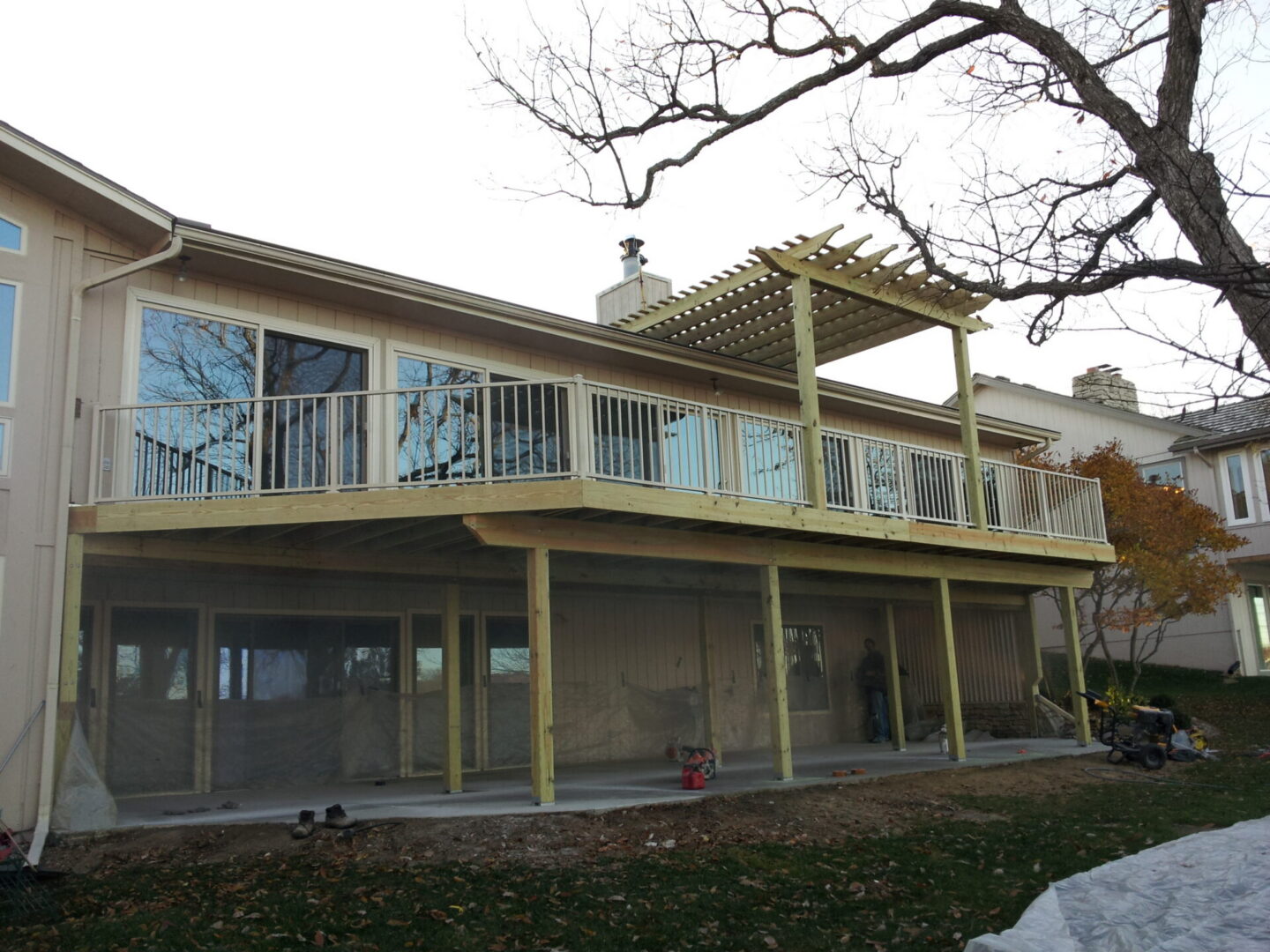 Two-story house with elevated deck and pergola