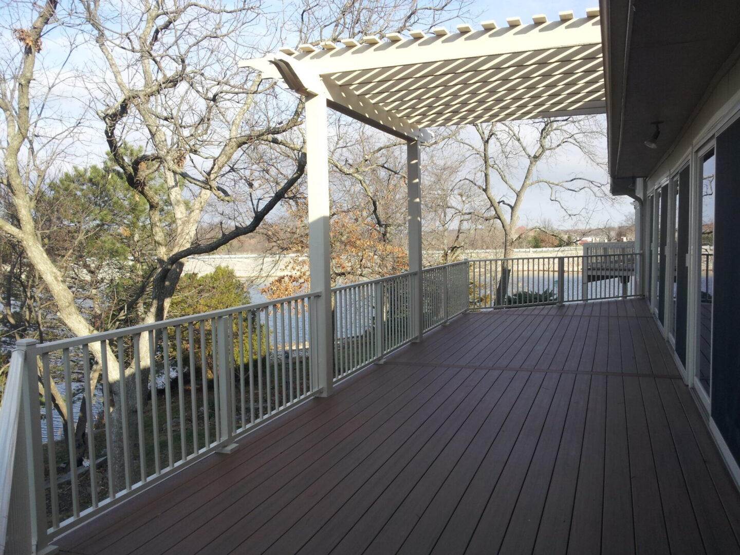 Spacious deck with pergola and white railing