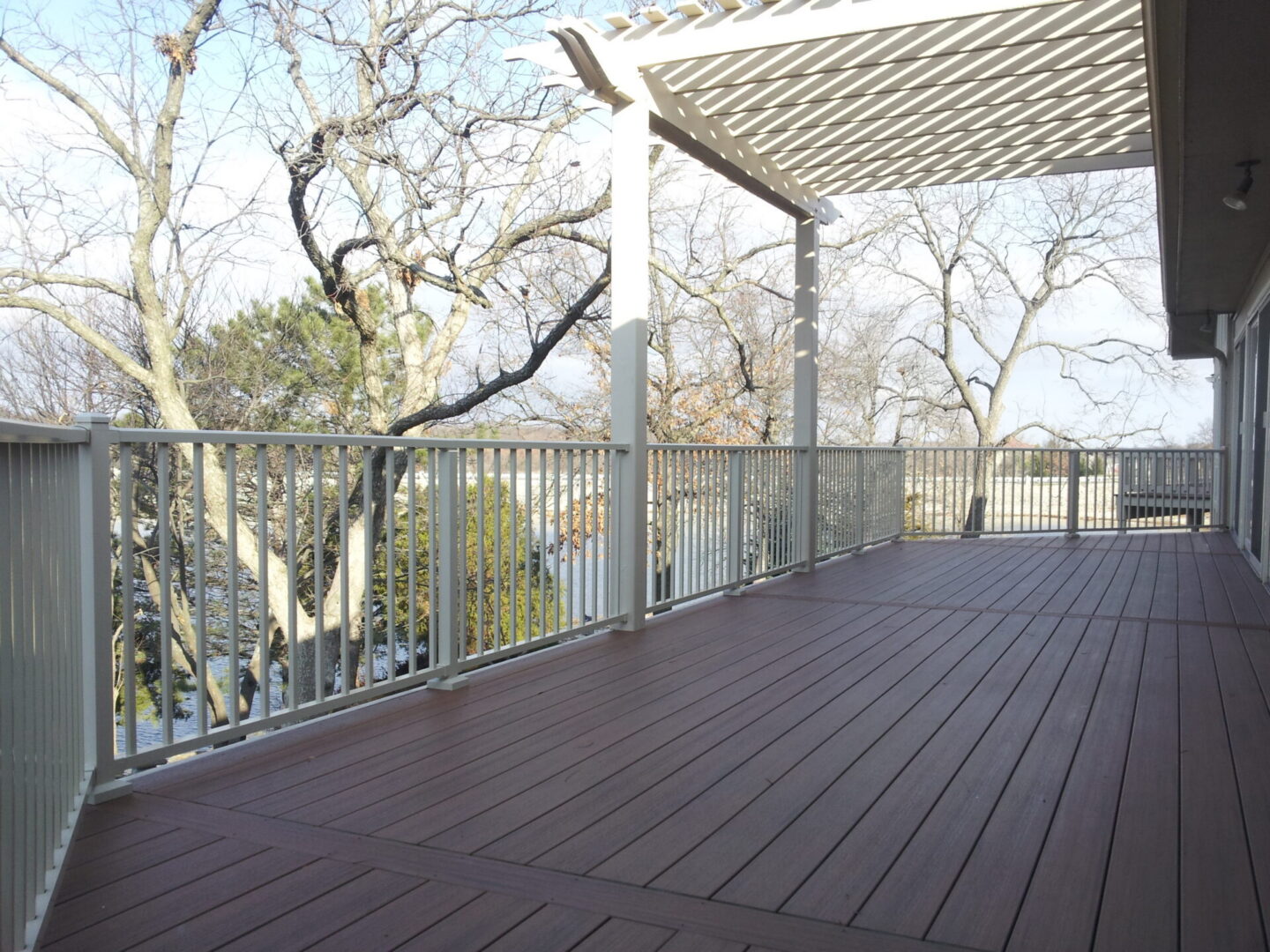 Spacious elevated deck with pergola and railing