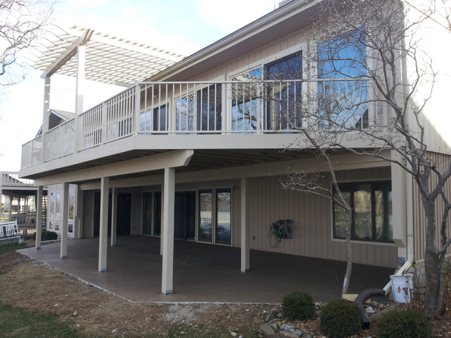 Two-story house with raised deck and patio