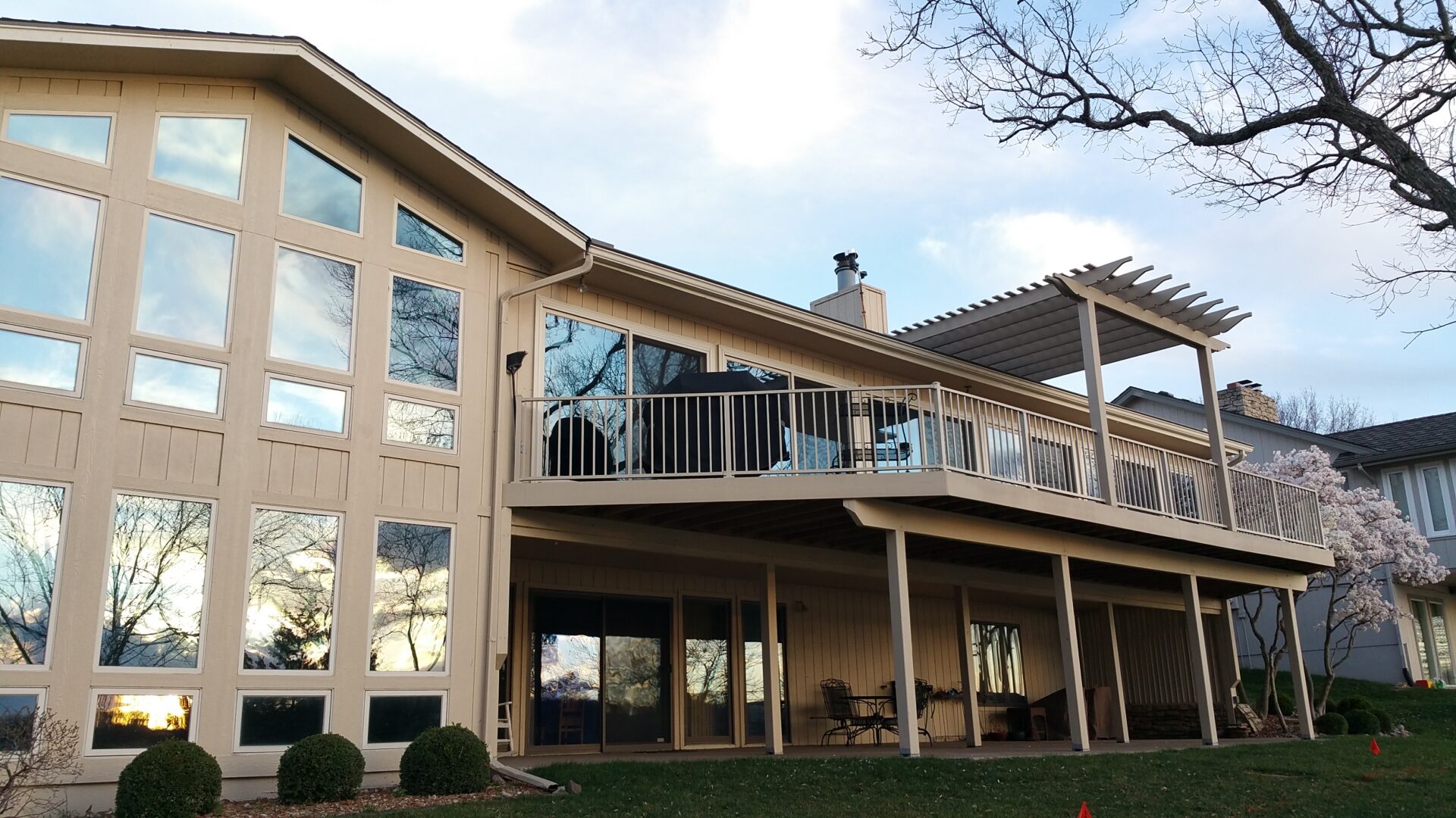 Two-story house with raised deck and pergola
