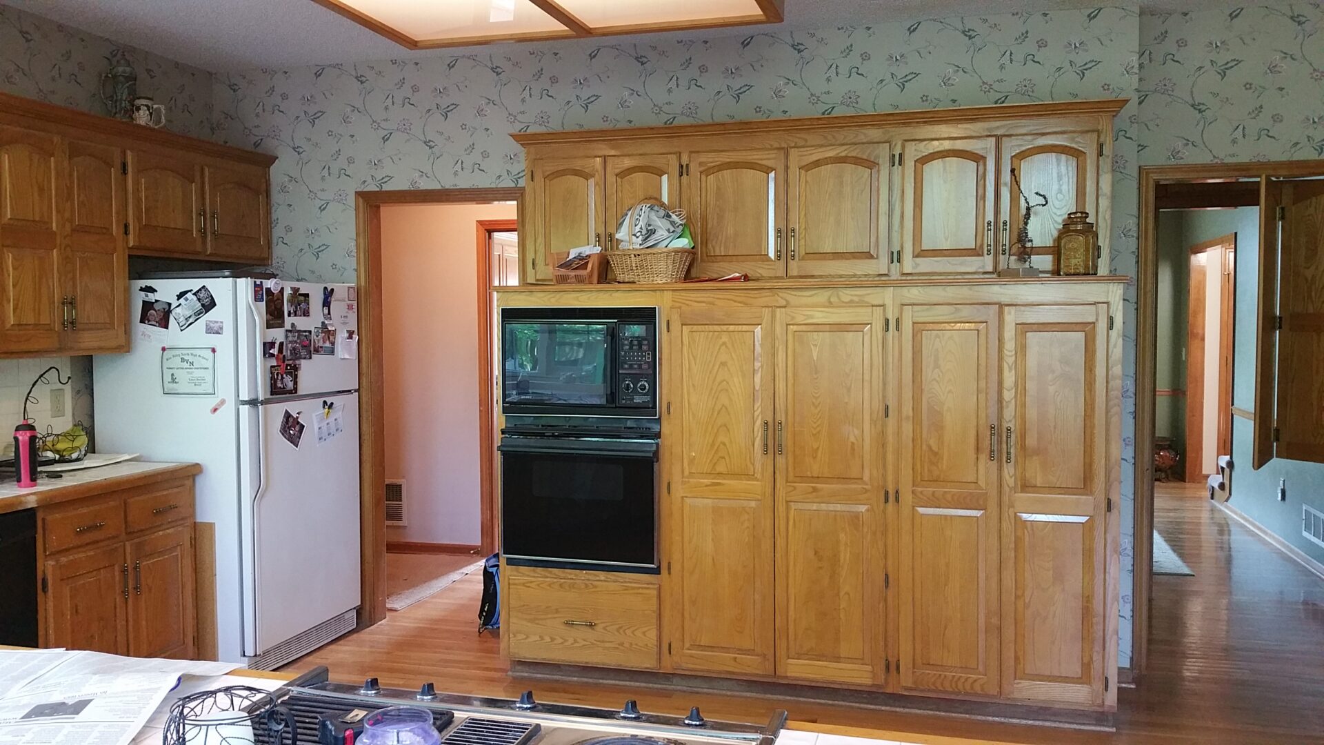Kitchen with oak cabinets, built-in oven, refrigerator