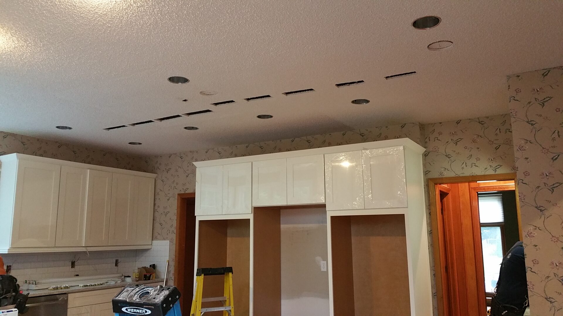 Kitchen renovation with cabinets and recessed ceiling lights