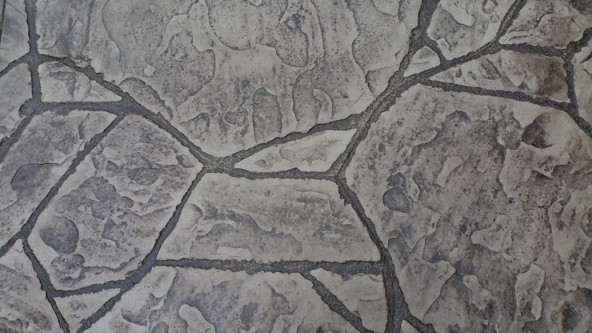 Textured gray stone pavement with dark joints
