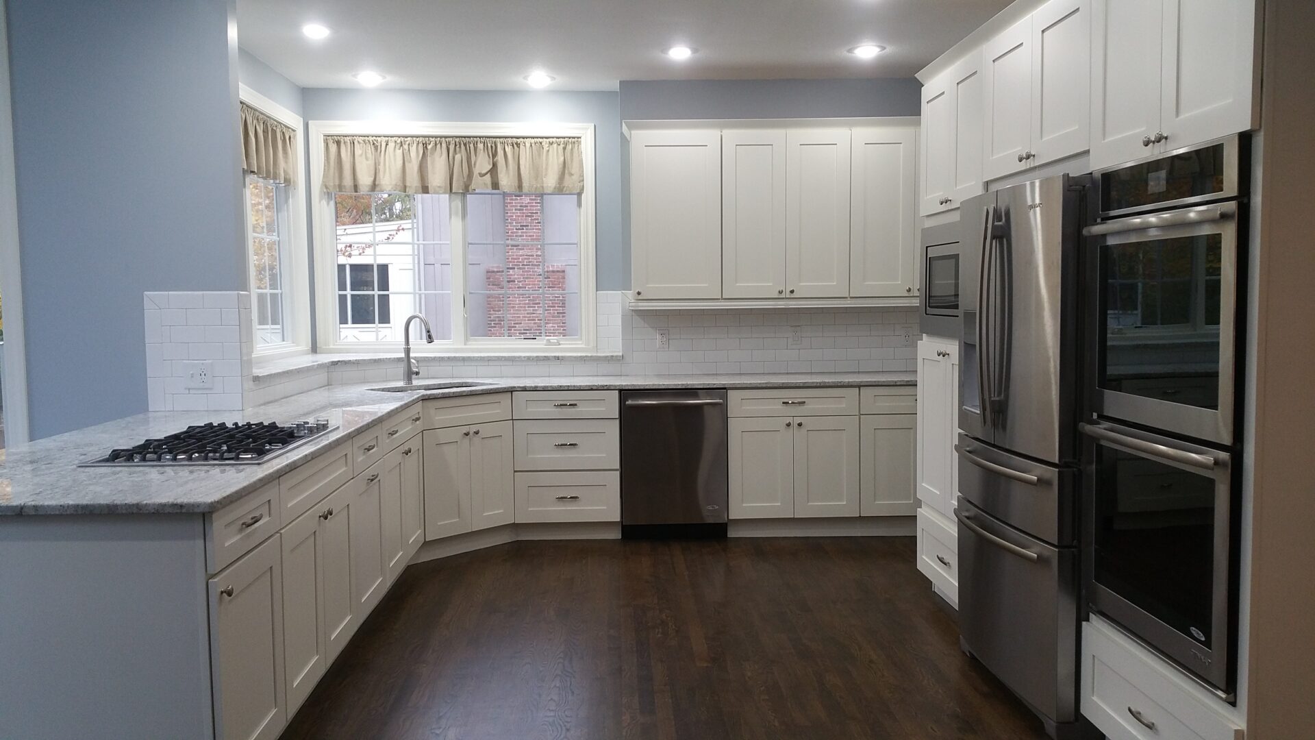 Bright white kitchen with stainless steel appliances