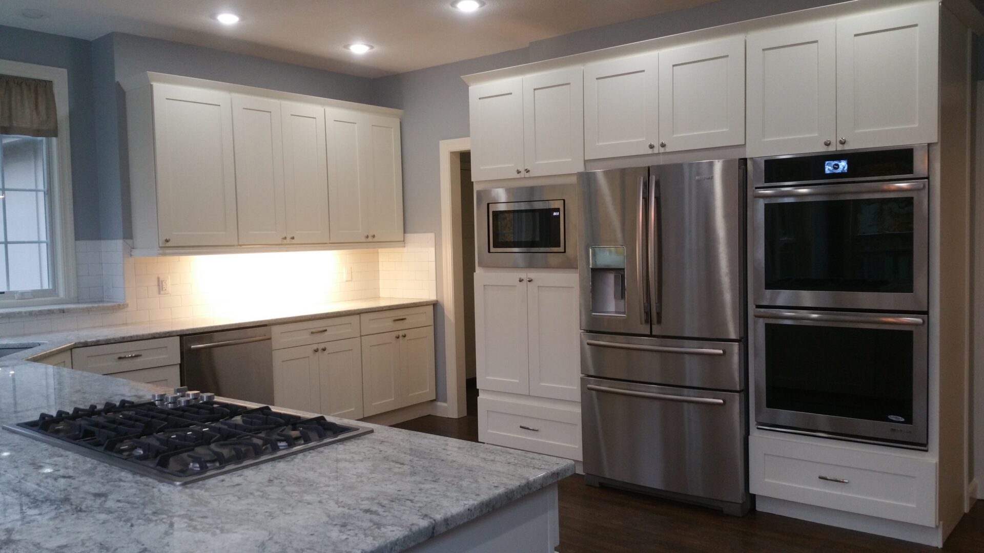 Modern kitchen with marble island and stainless appliances