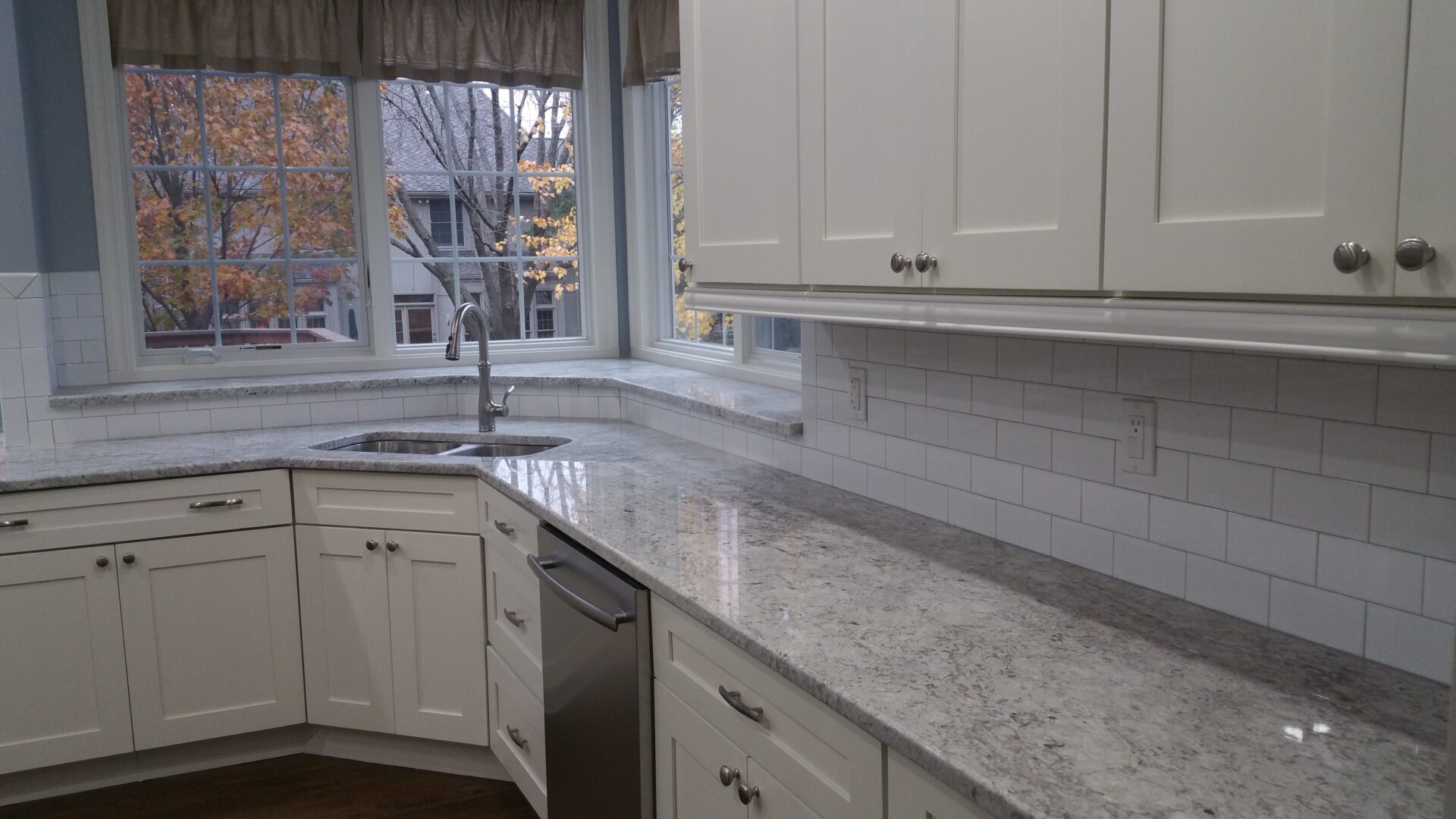 White kitchen with gray stone countertop