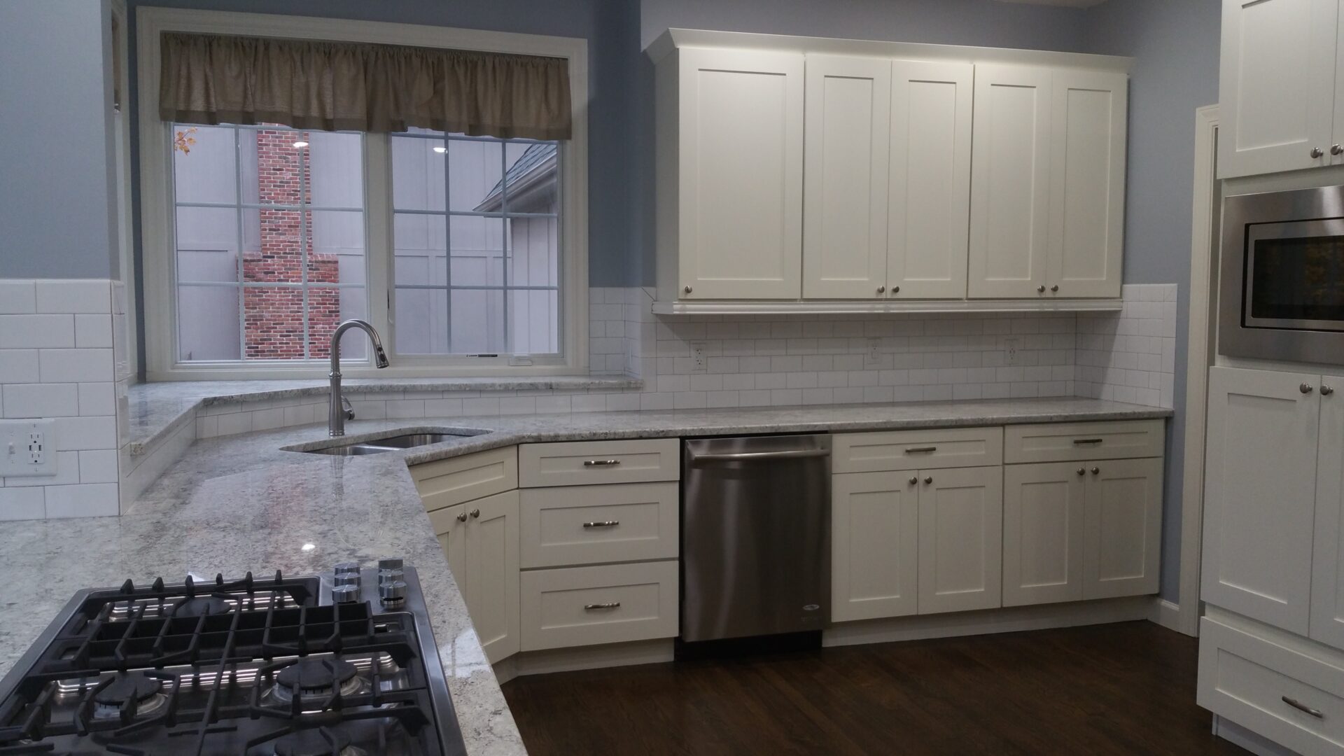 Bright modern white kitchen with stainless appliances