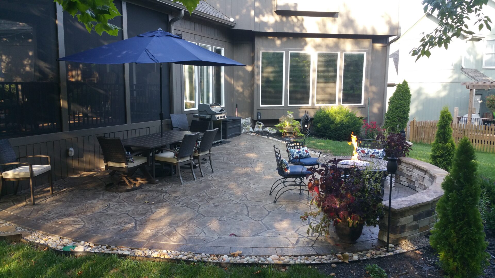 Stamped concrete patio with dining table and umbrella