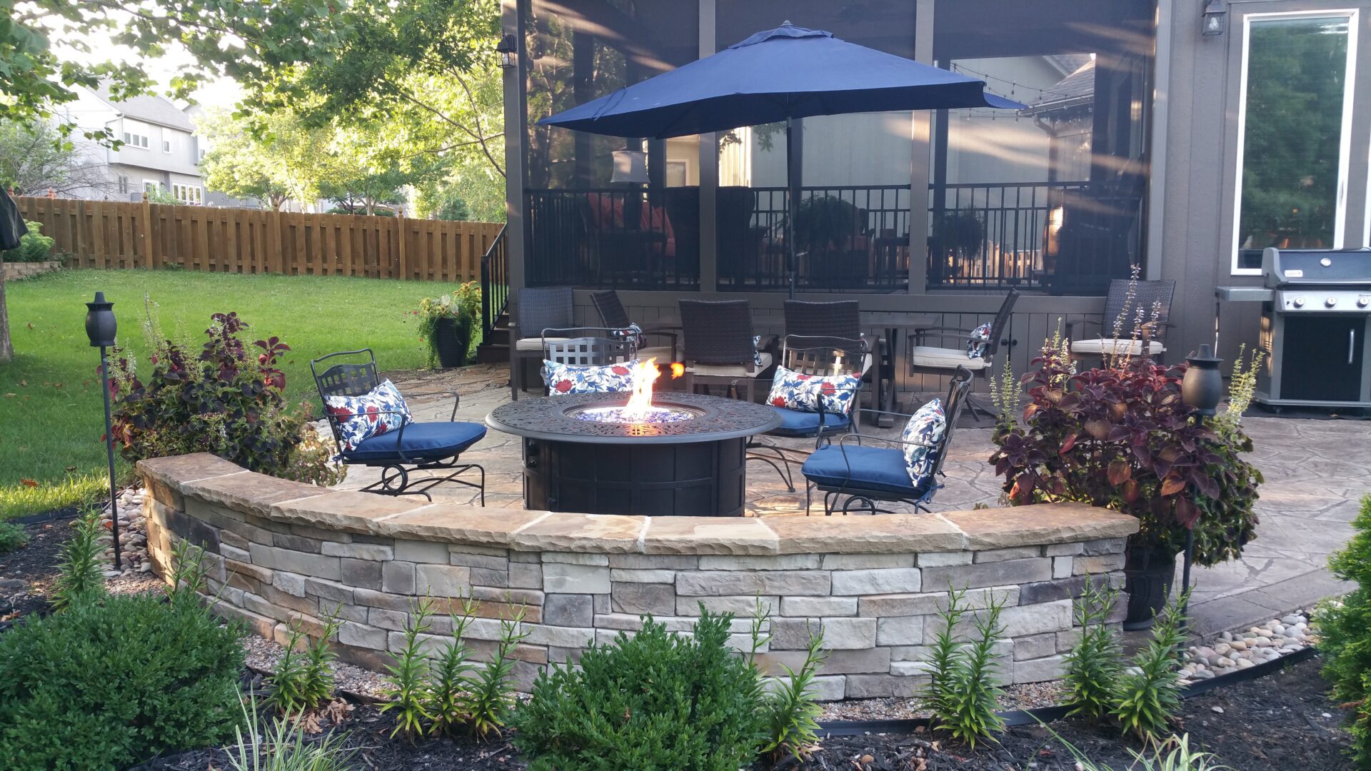 Backyard patio with stone fire pit and seating