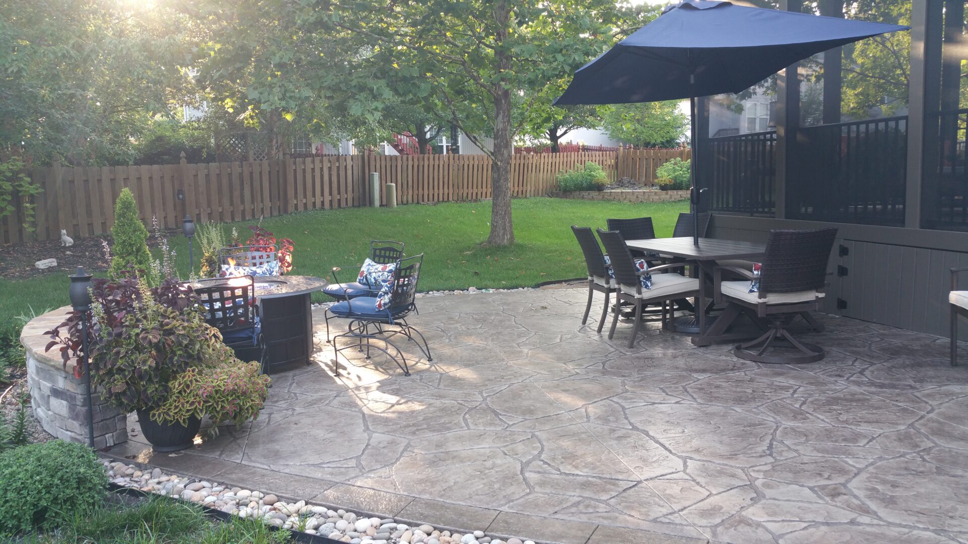 Backyard patio with dining table and umbrella