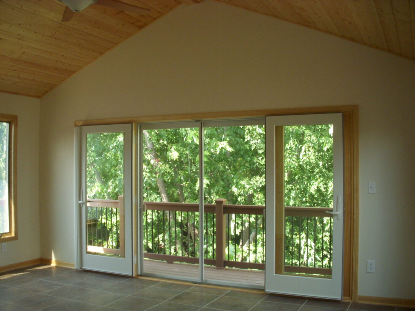 Empty room with sliding glass doors to deck