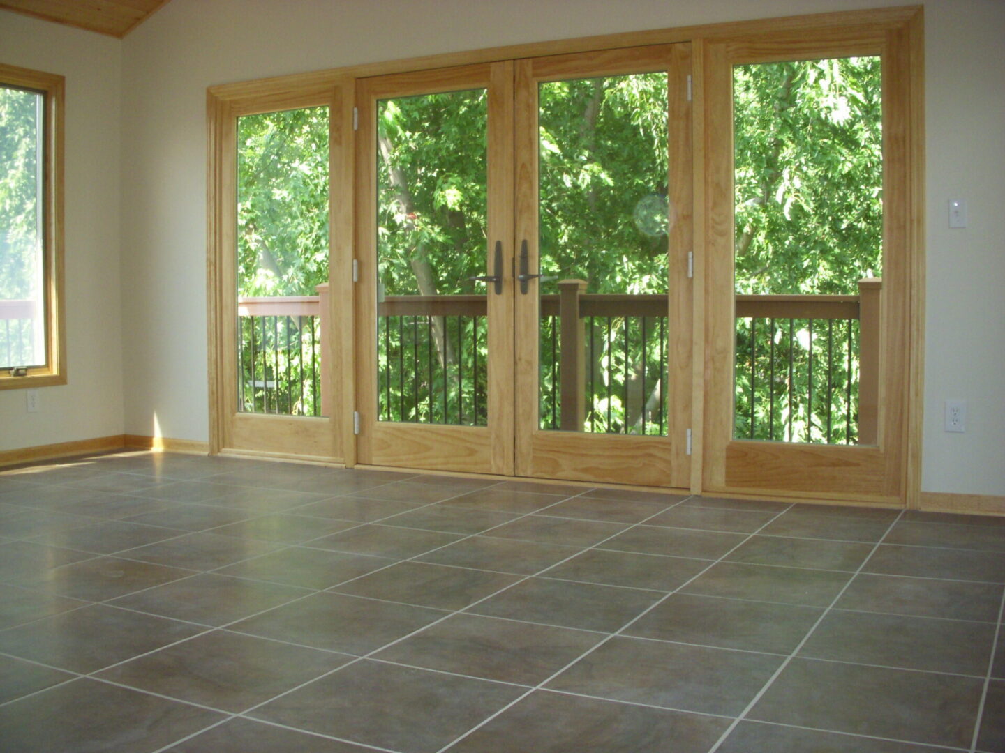 Empty room with tiled floor and French doors