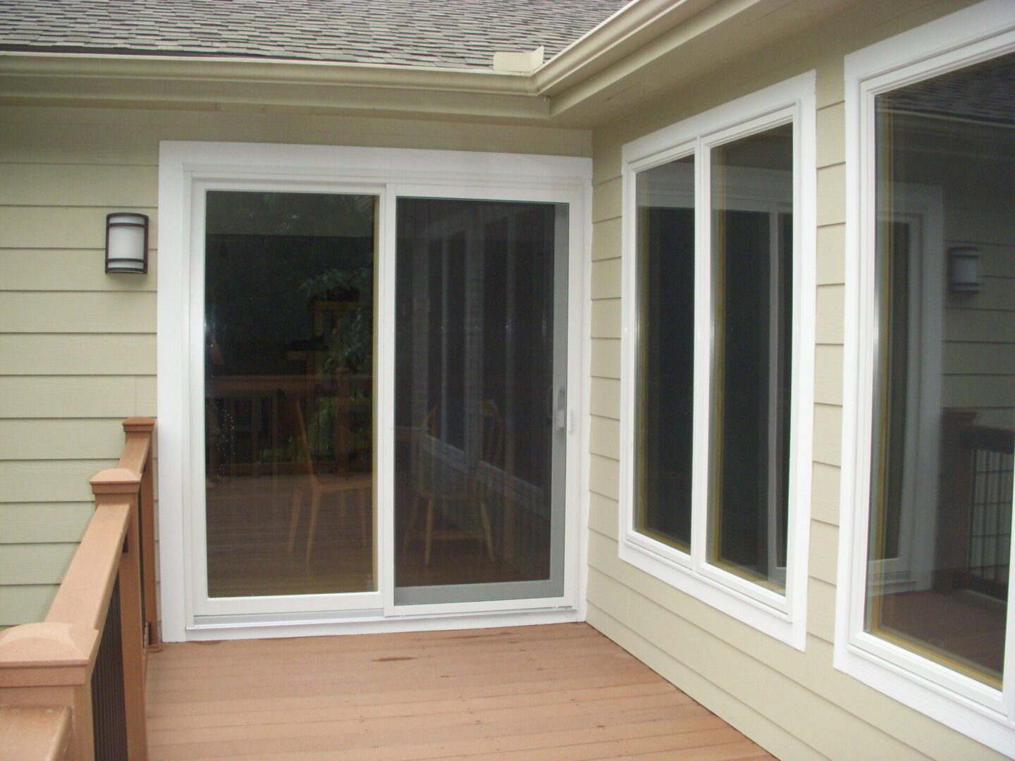 Wooden deck with sliding glass door and windows