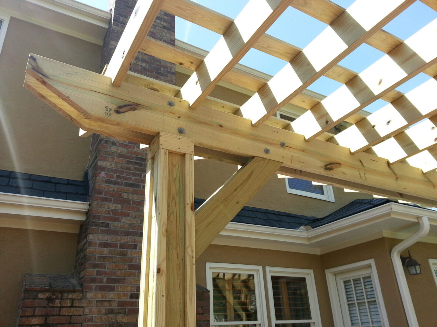 Wooden pergola over house patio