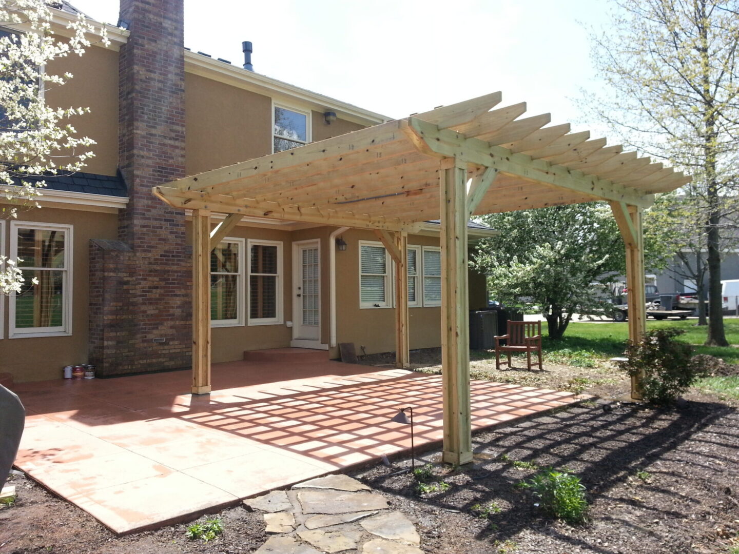 Wooden pergola over suburban backyard patio